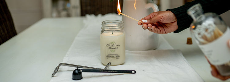 Large Matches lighting a peaches scented soy candle with candle accessories in front of it